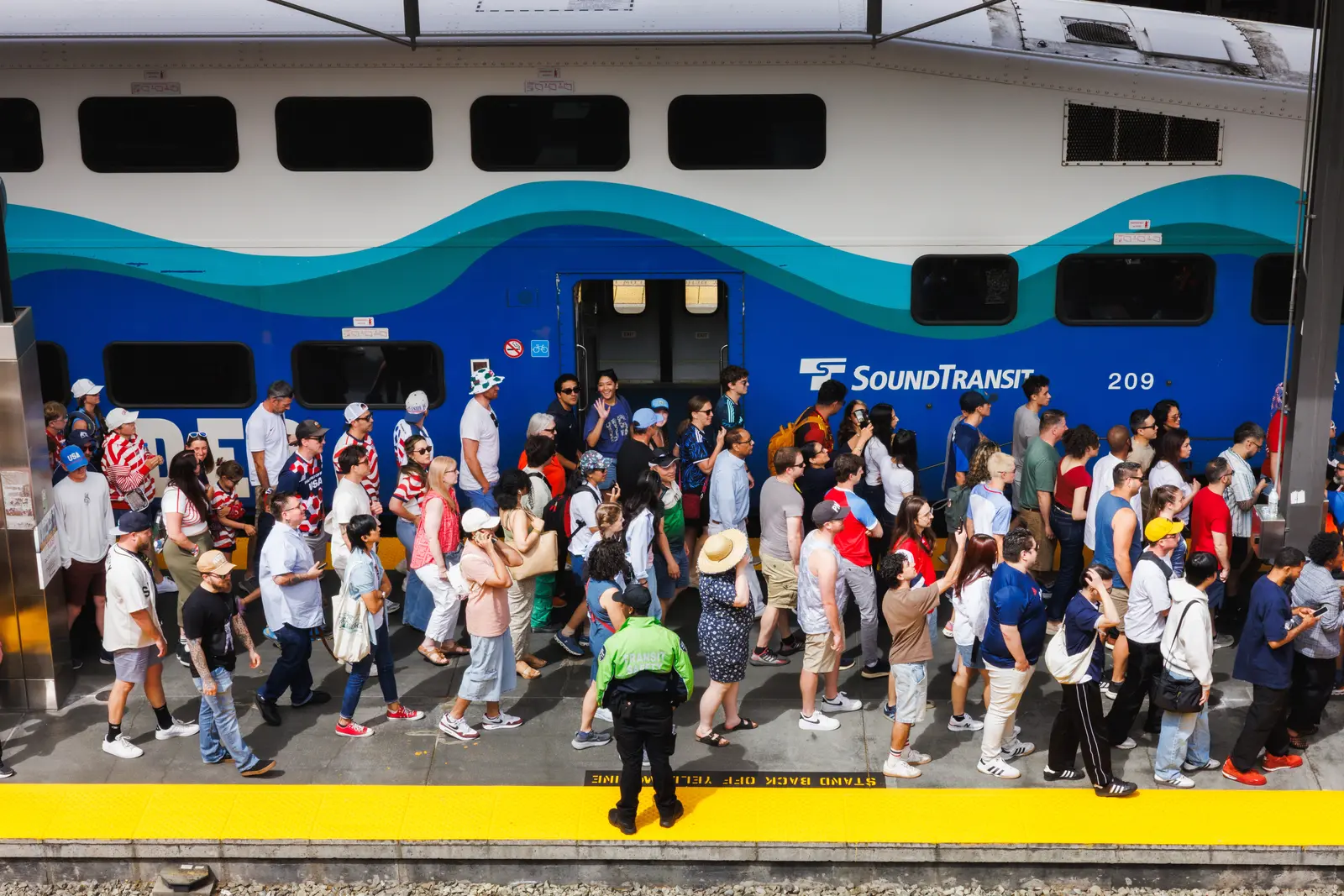 Soccer fans pack a Sound Transit commuter rail platform before a Seattle World Cup match