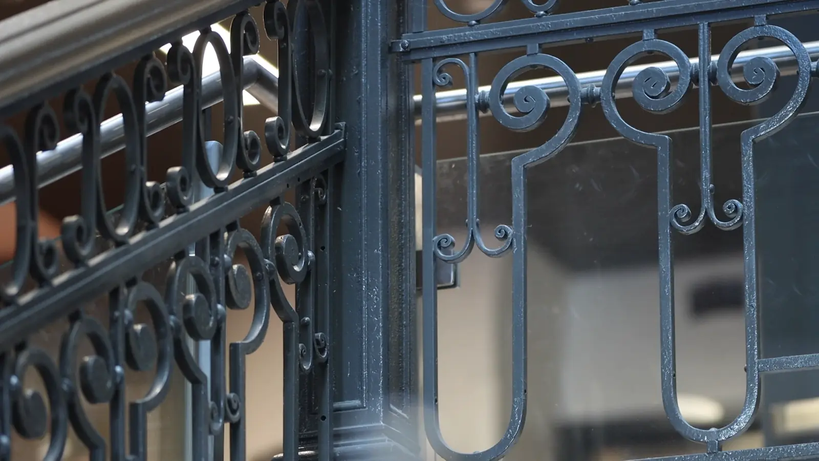 Still from documentary, close-up of the staircase railing's phallic-looking ironwork