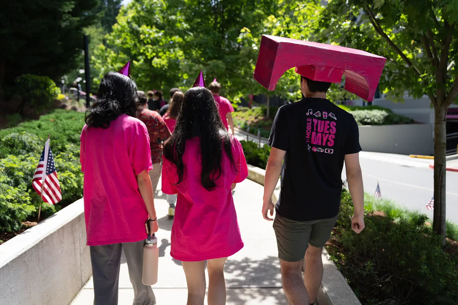 T-Mobile Club members and their mascot walk outside T-Mobile headquarters on a tour